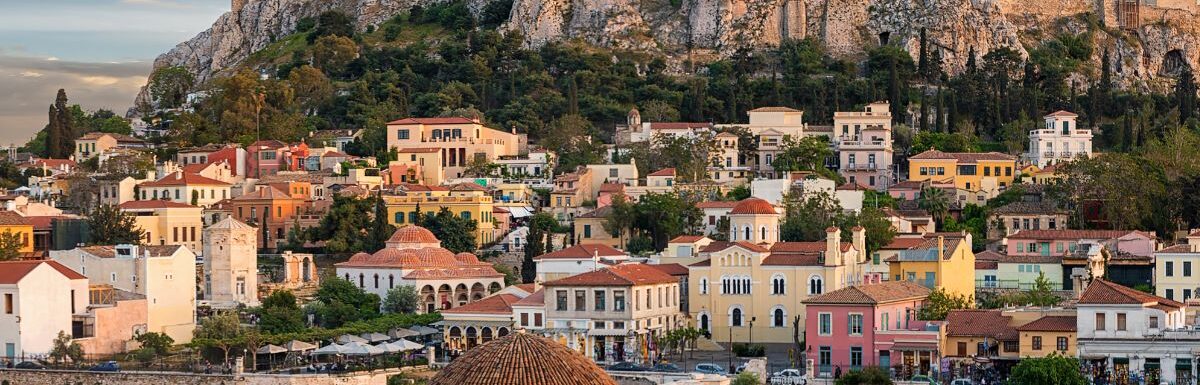 Panoramic view over the old town of Athens and the Parthenon Temple of the Acropolis during sunset.
