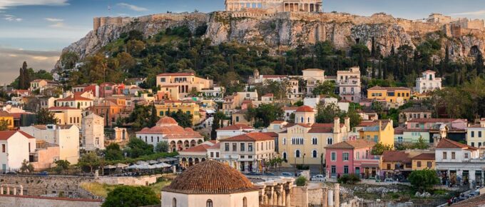 Panoramic view over the old town of Athens and the Parthenon Temple of the Acropolis during sunset.