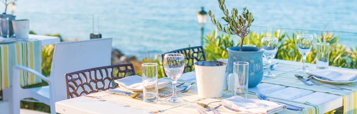 Beautiful tropical restaurant and beach with turquoise water in Corfu island, Greece.