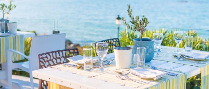 Beautiful tropical restaurant and beach with turquoise water in Corfu island, Greece.