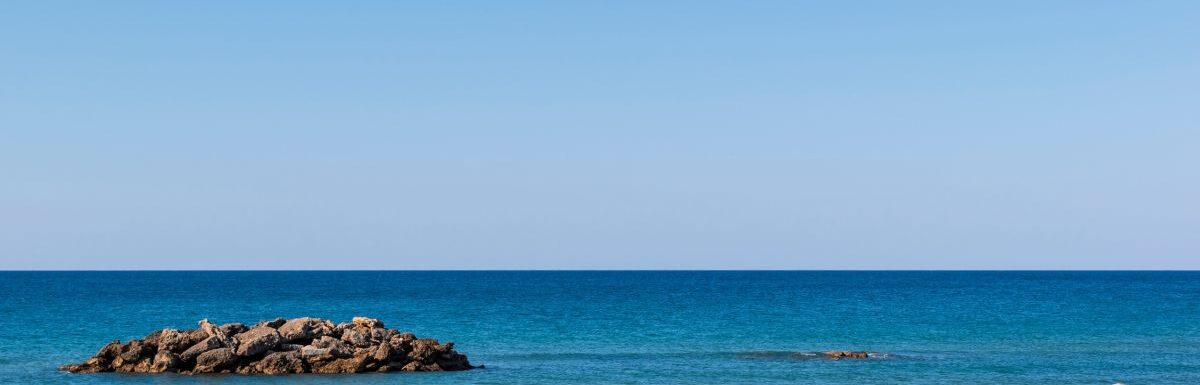 View of the deserted, sandy, windy beach on the western part of Corfu, the Chalikounas Beach.