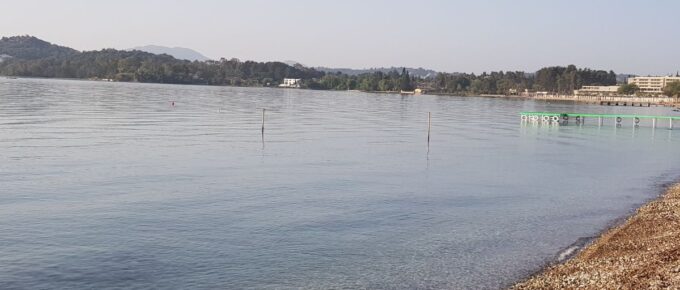 Calm Quiet Ionian Sea in the morning in Dassia, Corfu, Greece. Beautiful, warm, and perfect swimming water.