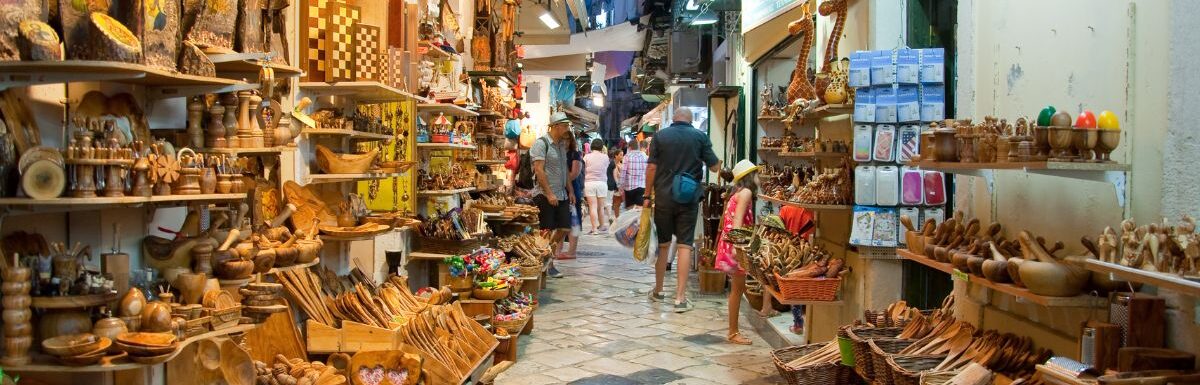 Tourists go shopping in local souvenir shops in Corfu island, Greece.