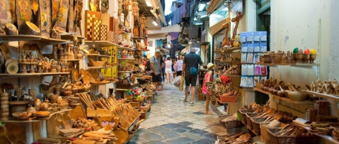 Tourists go shopping in local souvenir shops in Corfu island, Greece.