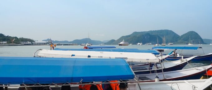 A group of people boards a boat for island hopping activity.