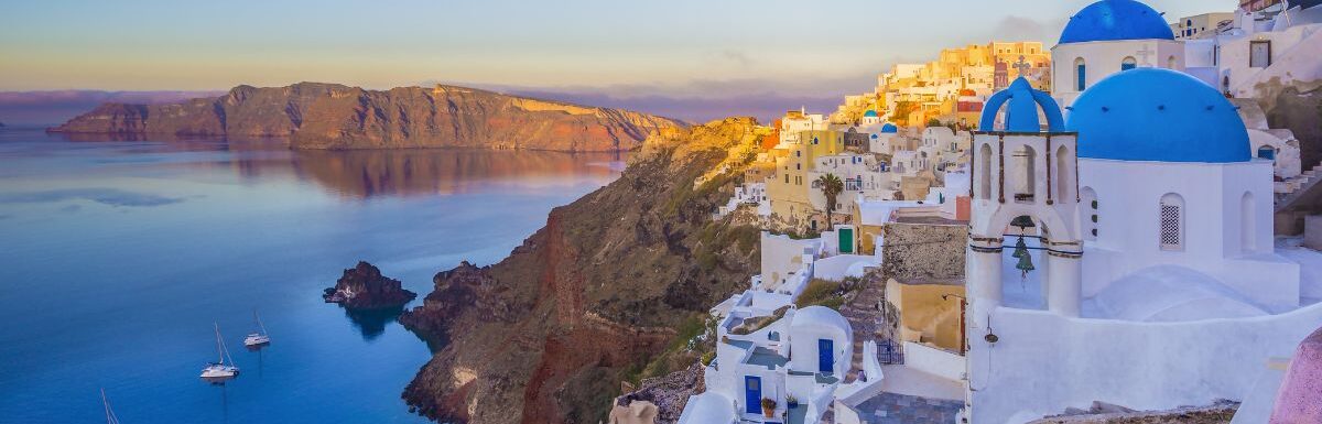 Oia village in the morning with dusk sky colors in Santorini, Greece.