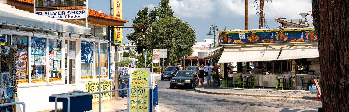 Central crossroads with thermometer, showing hot weather temperature, in pharmacy sign in Faliraki town in Rhodes island, Greece