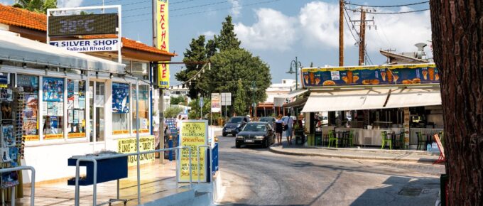 Central crossroads with thermometer, showing hot weather temperature, in pharmacy sign in Faliraki town in Rhodes island, Greece