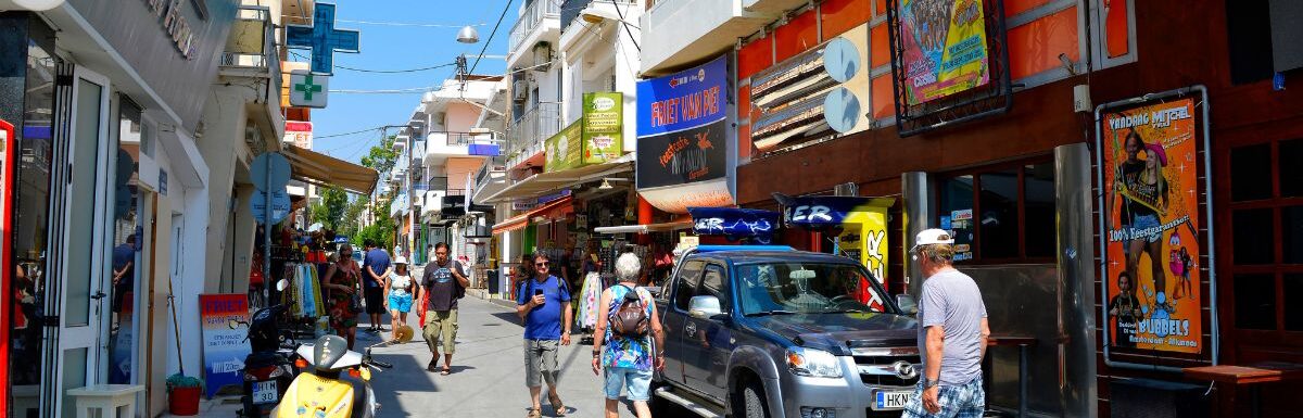 Tourists shopping in Hersonissos town, Crete, Greece, on a sunny day.