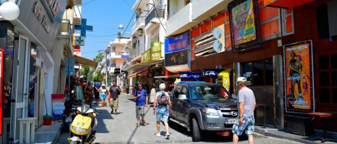 Tourists shopping in Hersonissos town, Crete, Greece, on a sunny day.