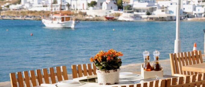 Dining table at restaurant by the water front at Mykonos, Greece, on a sunny day.