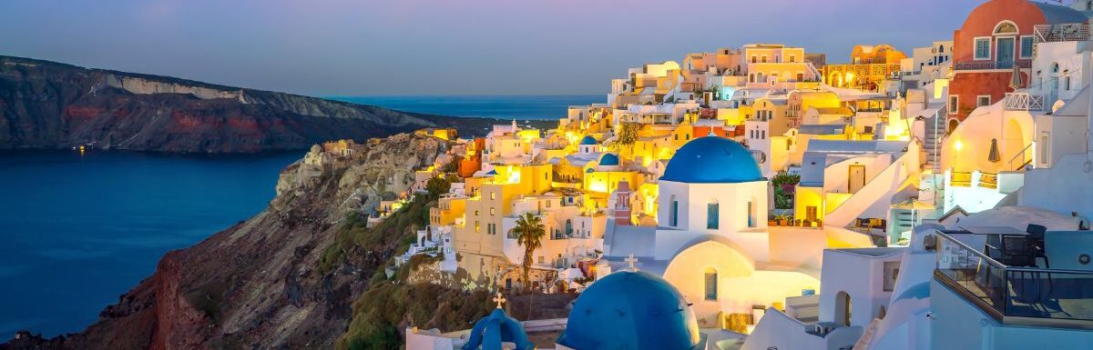 Oia town cityscape at Santorini island in Greece at sunset.