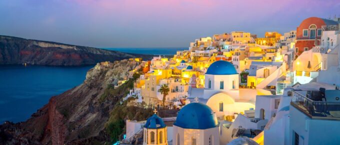 Oia town cityscape at Santorini island in Greece at sunset.