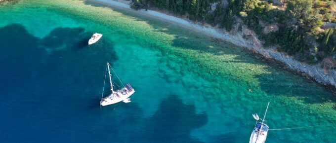 Aerial drone top down photo of sail boats anchored in small port of Frikes in Ithaca island, Ionian, Greece.