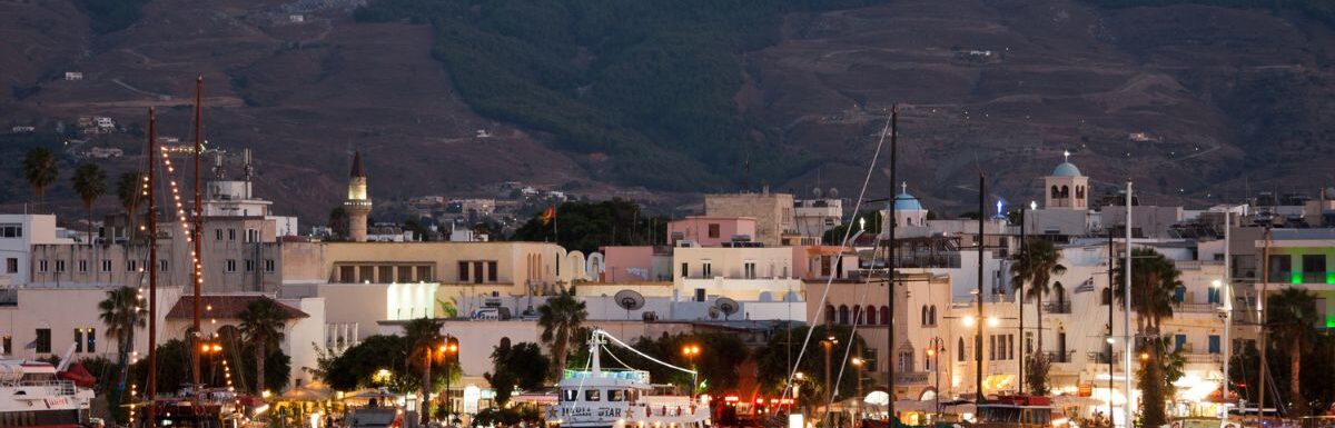 Typical wooden daily boats trip in the port of Kos Town at night in Kos, Greece.