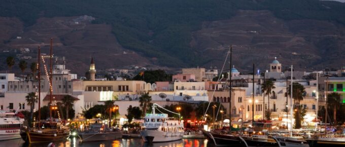 Typical wooden daily boats trip in the port of Kos Town at night in Kos, Greece.