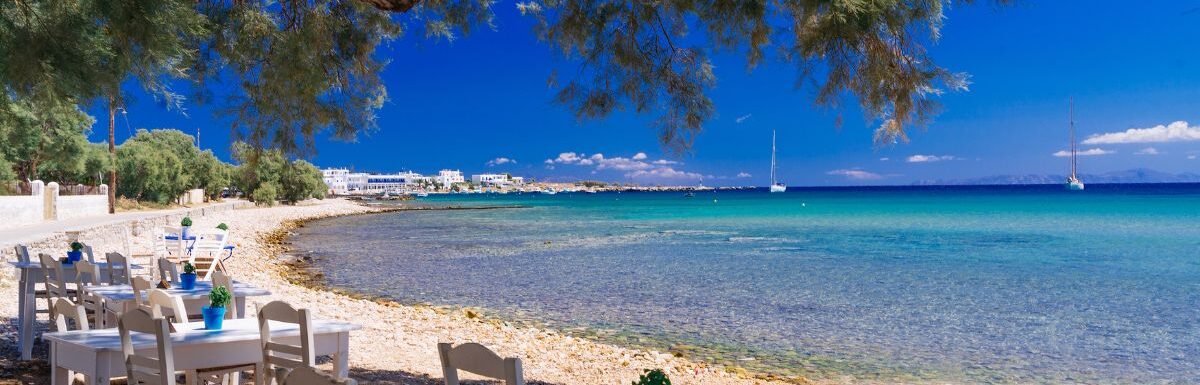 Cute little tavern in the olive shade on Paros island, Cycladic paradise resort, Cyclades, Greece.