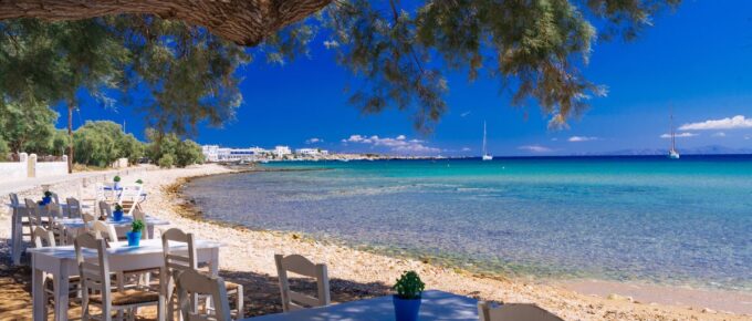 Cute little tavern in the olive shade on Paros island, Cycladic paradise resort, Cyclades, Greece.