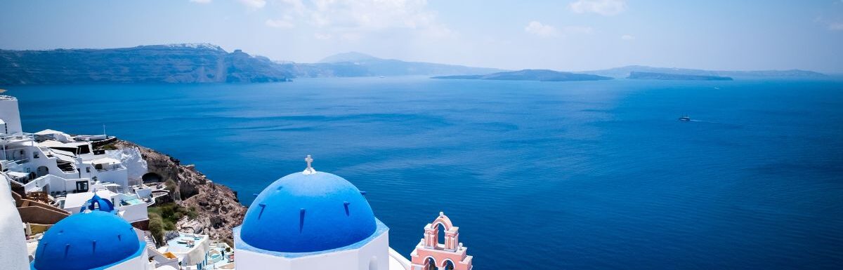 Blue dome church and the Sea in Oia, Santorini, Greece, Aegean Sea.