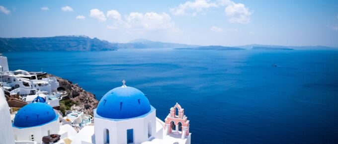 Blue dome church and the Sea in Oia, Santorini, Greece, Aegean Sea.