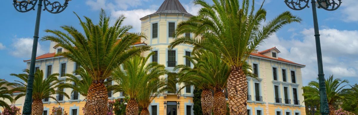 Hotel and palm trees at Greek spa resort Loutra Edipsou on island of Euboea in Greece.