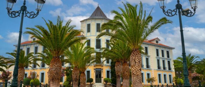 Hotel and palm trees at Greek spa resort Loutra Edipsou on island of Euboea in Greece.