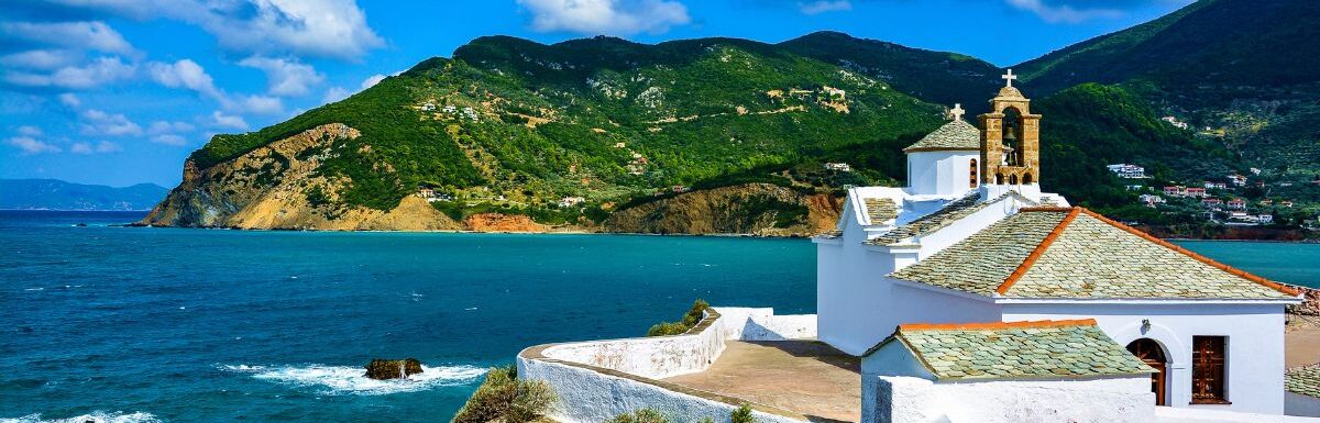 View of Panagitsa Tou Pirgou church over the bay, Skopelos, Greece.