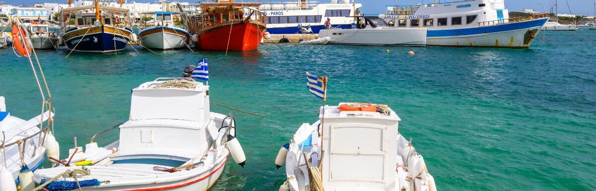 White Greek boats anchoring in port of Antiparos island, Greece.