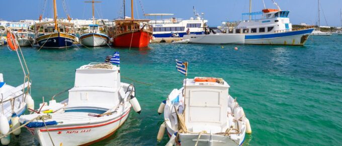 White Greek boats anchoring in port of Antiparos island, Greece.