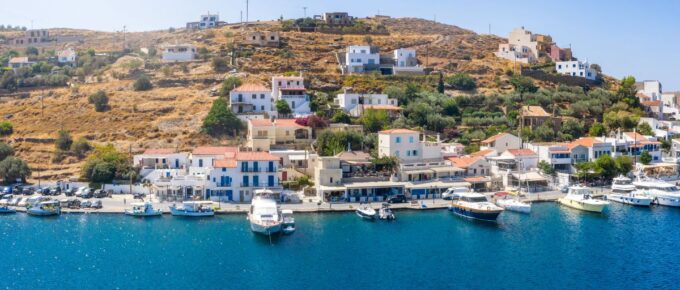 The small village of Vourkari on the island of Tzia, Kea, Greece, with moored yachts and sailboats in the Marina.