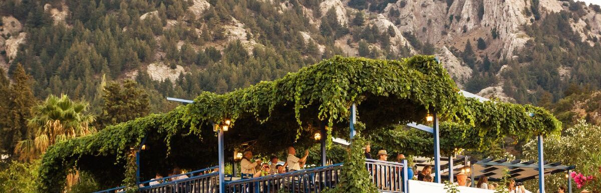 Greek tavern's terrace decorated with green grapes on the hill at Kos island, Greece.