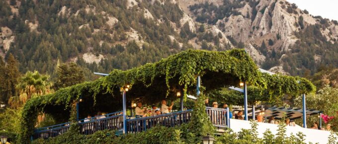 Greek tavern's terrace decorated with green grapes on the hill at Kos island, Greece.