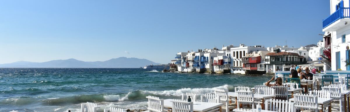 Waterfront in Little Venice Mykonos Chora with restaurants and tourists, Mykonos island, Mikonos, Cyclades islands, Aegean sea, Greece in July.