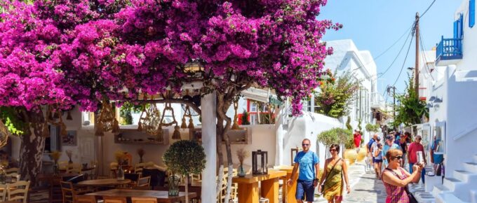 Shops and bars by street at the famous tourist spot of downtown on island Mykonos, Greece on June 2015.