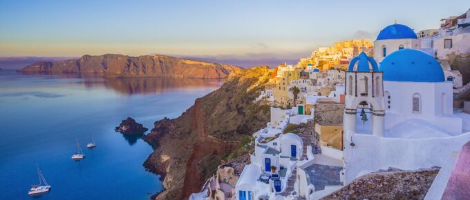 Oia village in the morning with dusk sky colors in Santorini, Greece.