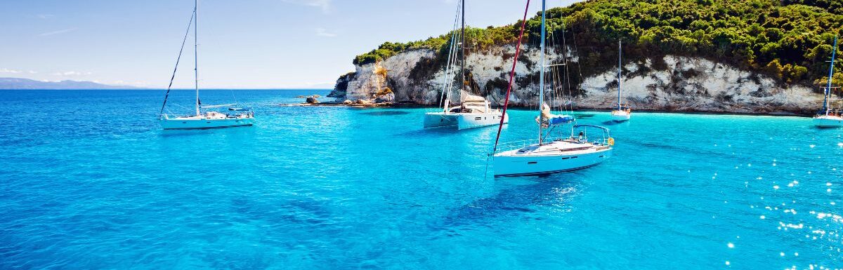 Sailboats in a beautiful bay, Paxos island, Greece.