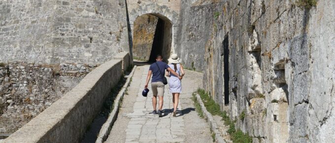 Young couple walking at the Old Fortress of Corfu Town, Old Town of Corfu, Greece.