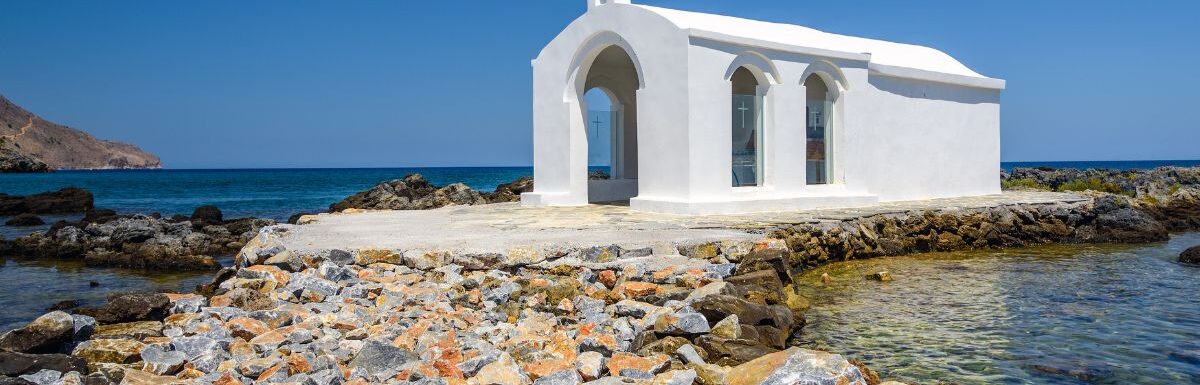 Small white church in the sea near Georgioupolis town on Crete island, Greece.