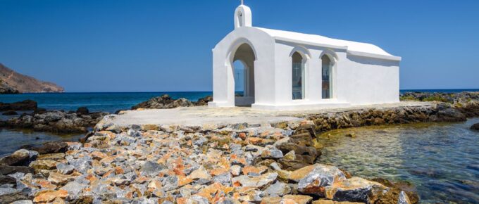 Small white church in the sea near Georgioupolis town on Crete island, Greece.