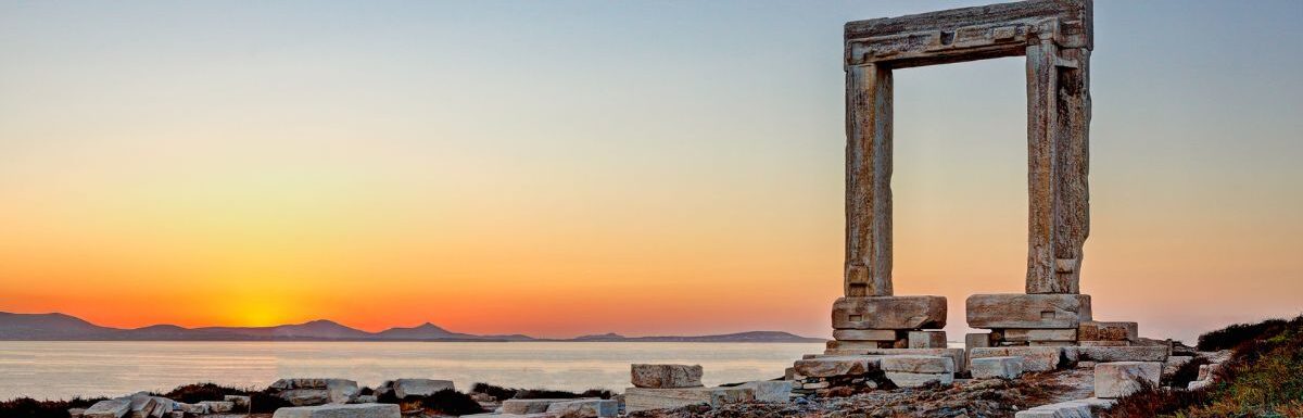 The sunset from Portara in Chora of Naxos island, Greece.