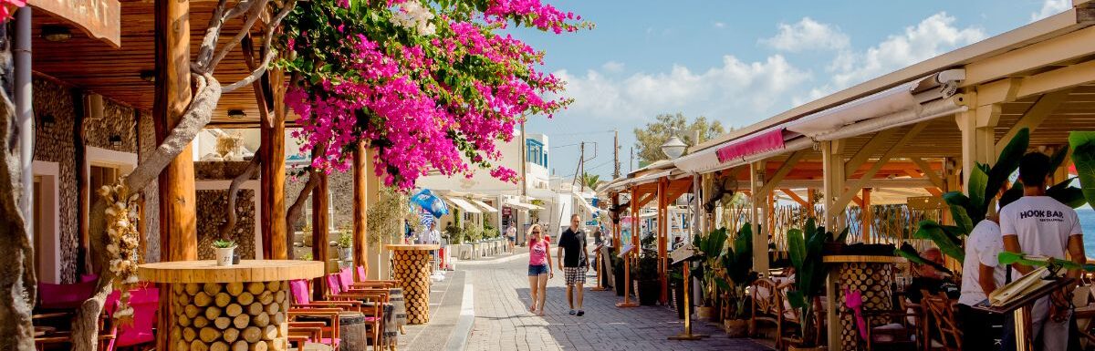 Kamari village main street promenade with restaurants and shops on island of Santorini.