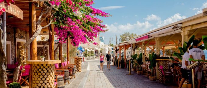 Kamari village main street promenade with restaurants and shops on island of Santorini.