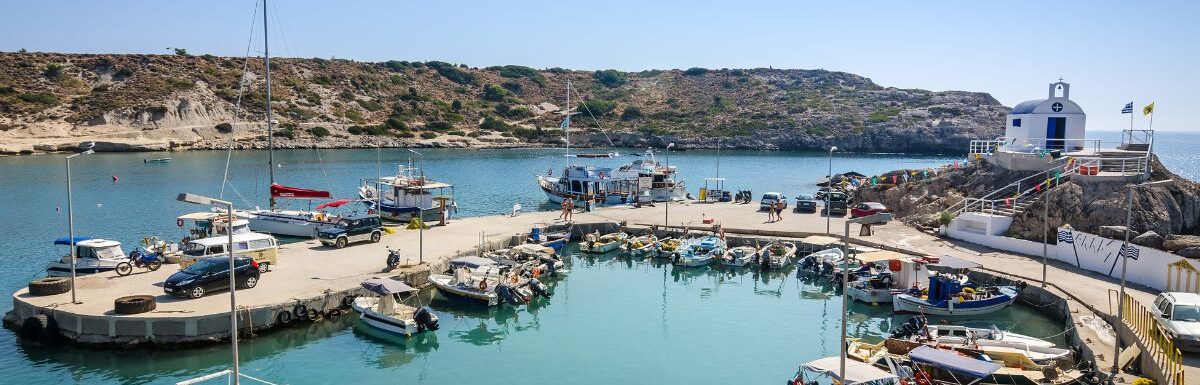 Sea bay with moored boats in Kolymbia harbor, in Rhodes, Greece.