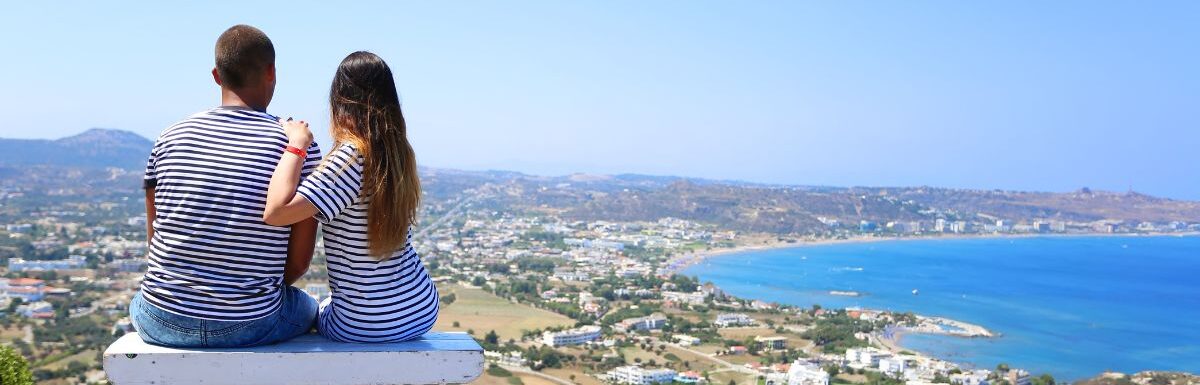 A loving couple, and a beautiful view of the sea. Summer time. Rhodes, Greece.