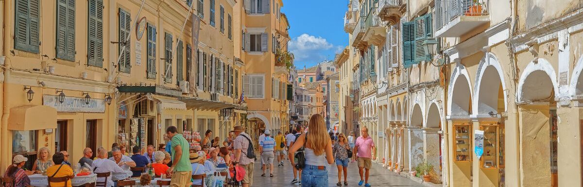 Tourists and locals relaxing in the city centre scenes of everyday life in Corfu, Greece.