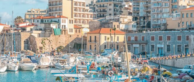 Boats and yachts in the port on the background of Heraklion city, Crete, Greece.