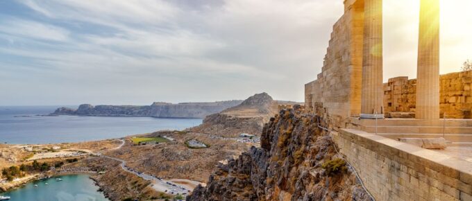 Doric columns of the ancient Temple of Athena Lindia setting sun above the columns in the Acropolis of Lindos, Rhodes, Greece.