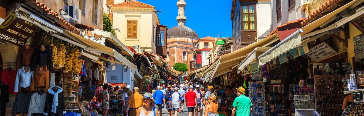 Many tourists visiting and shopping at market street in the old town Rhodos, Greece on June 2015.