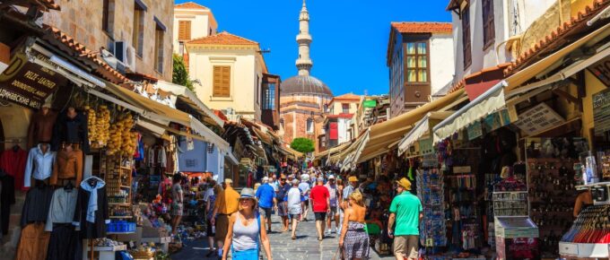 Many tourists visiting and shopping at market street in the old town Rhodos, Greece on June 2015.