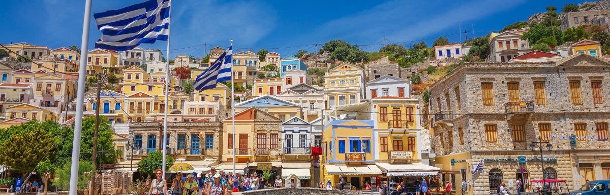 Scenic view with beautiful traditional houses and colorful buildings at the port of Symi island near Rhodes, Greece.